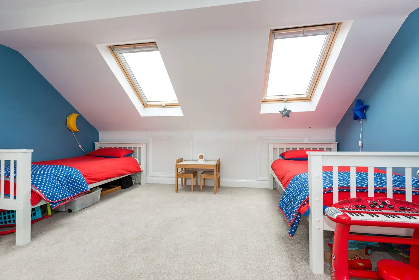 Matching children's beds on either side of dormer loft conversion