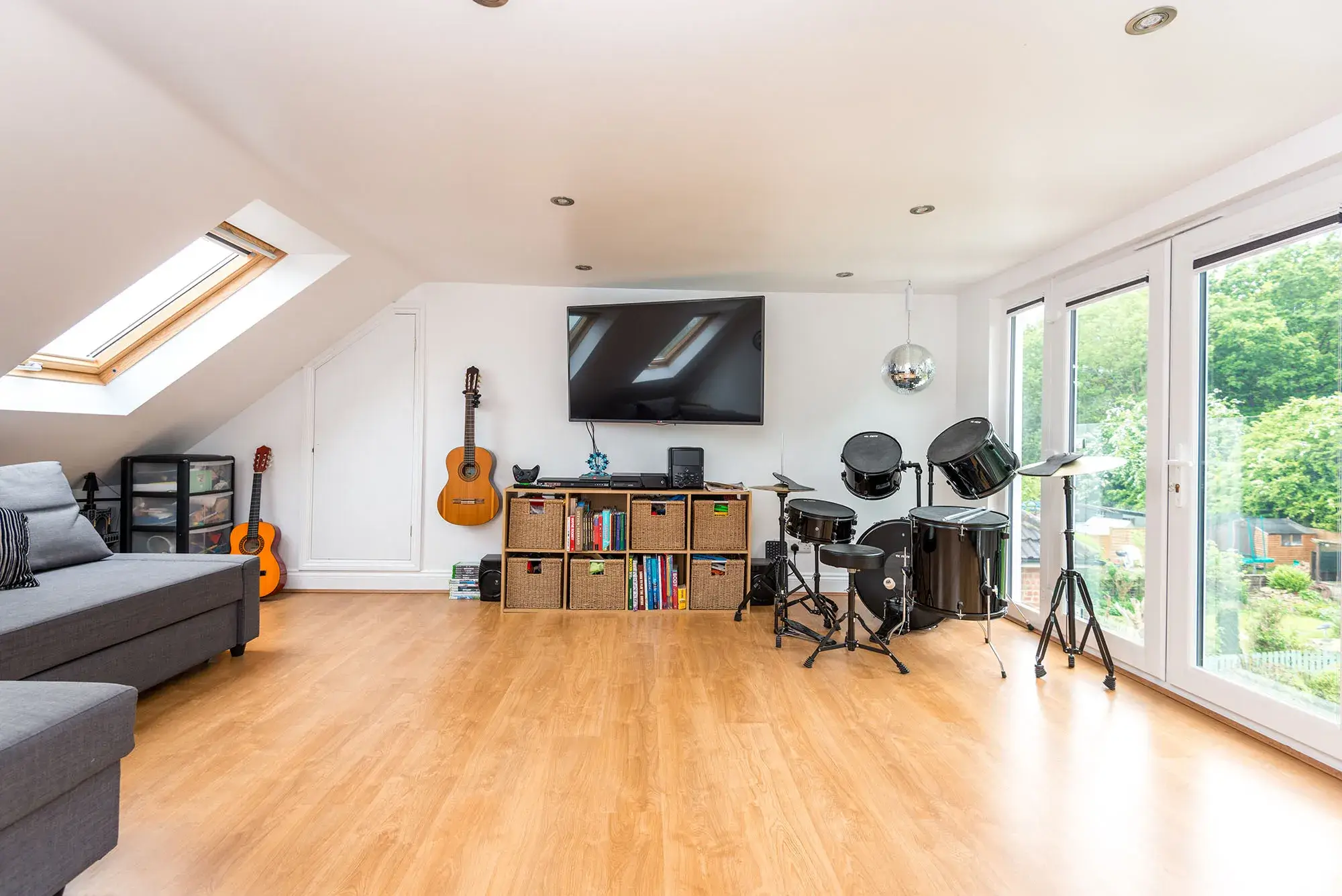 A loft converted into a music room, with drums and guitars