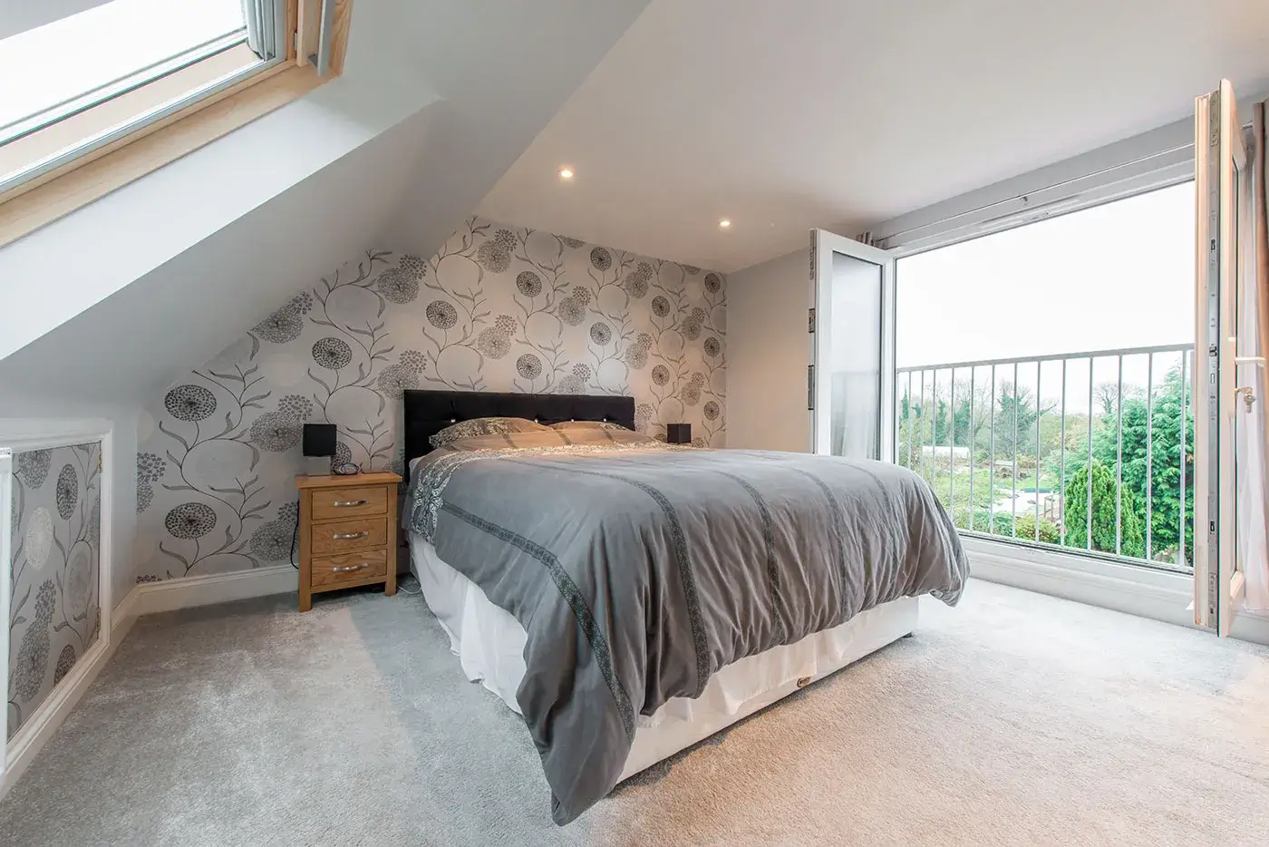 Master bedroom in dormer conversion, with open Velux windows